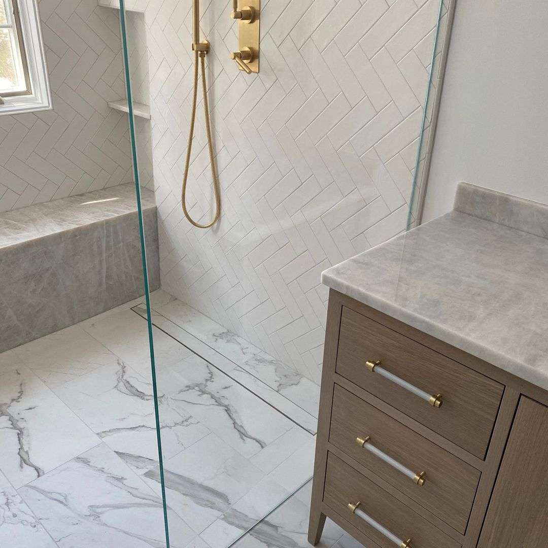 Modern bathroom with marble tiles and gold fixtures