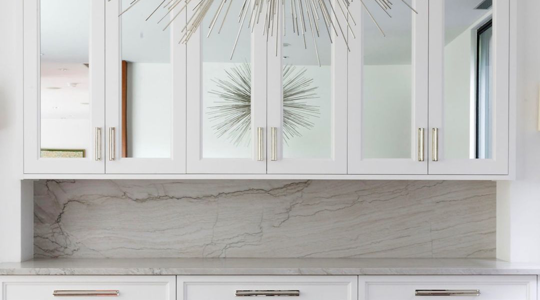 Modern kitchen with white cabinets and marble backsplash